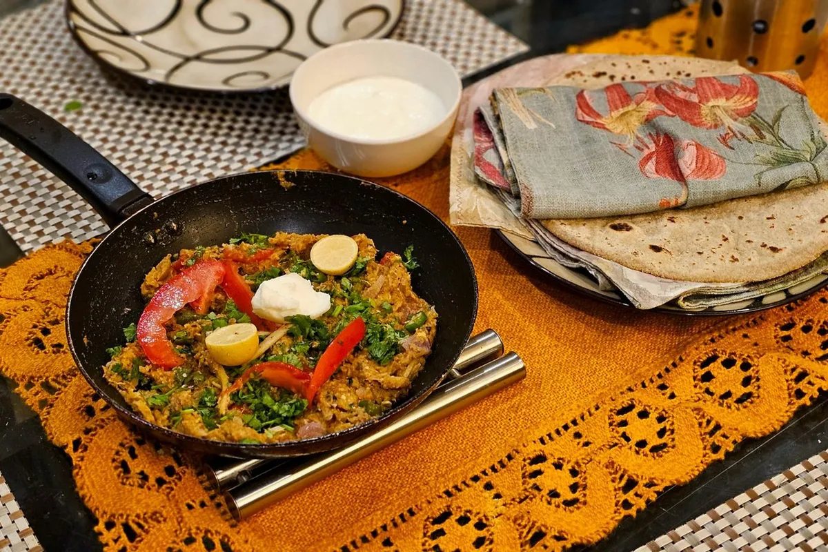 A bowl of smoky baingan bharta garnished with coriander