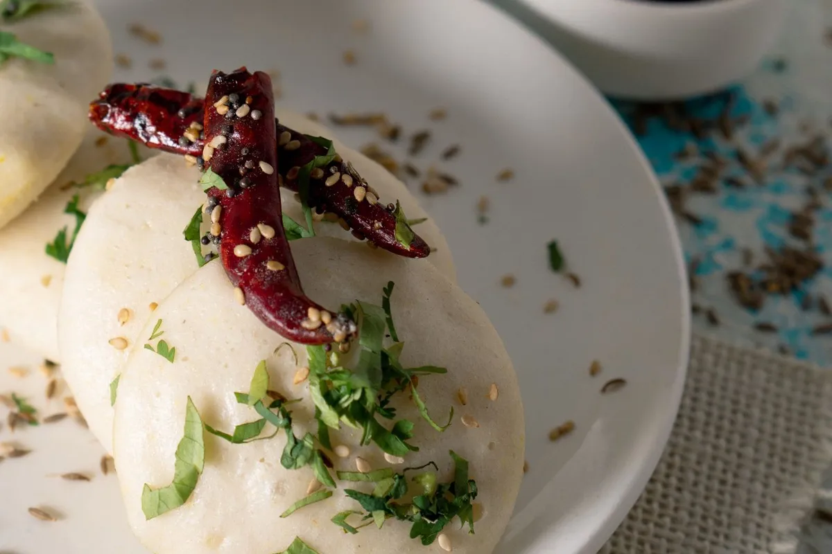 Squares of steamed besan dhokla with a tempering