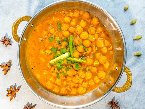 A bowl of chana masala with chickpeas in a spiced gravy