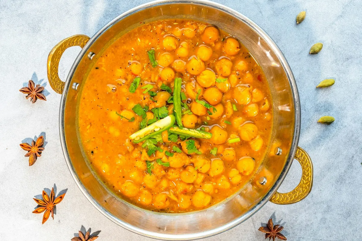 A bowl of chana masala with chickpeas in a spiced gravy