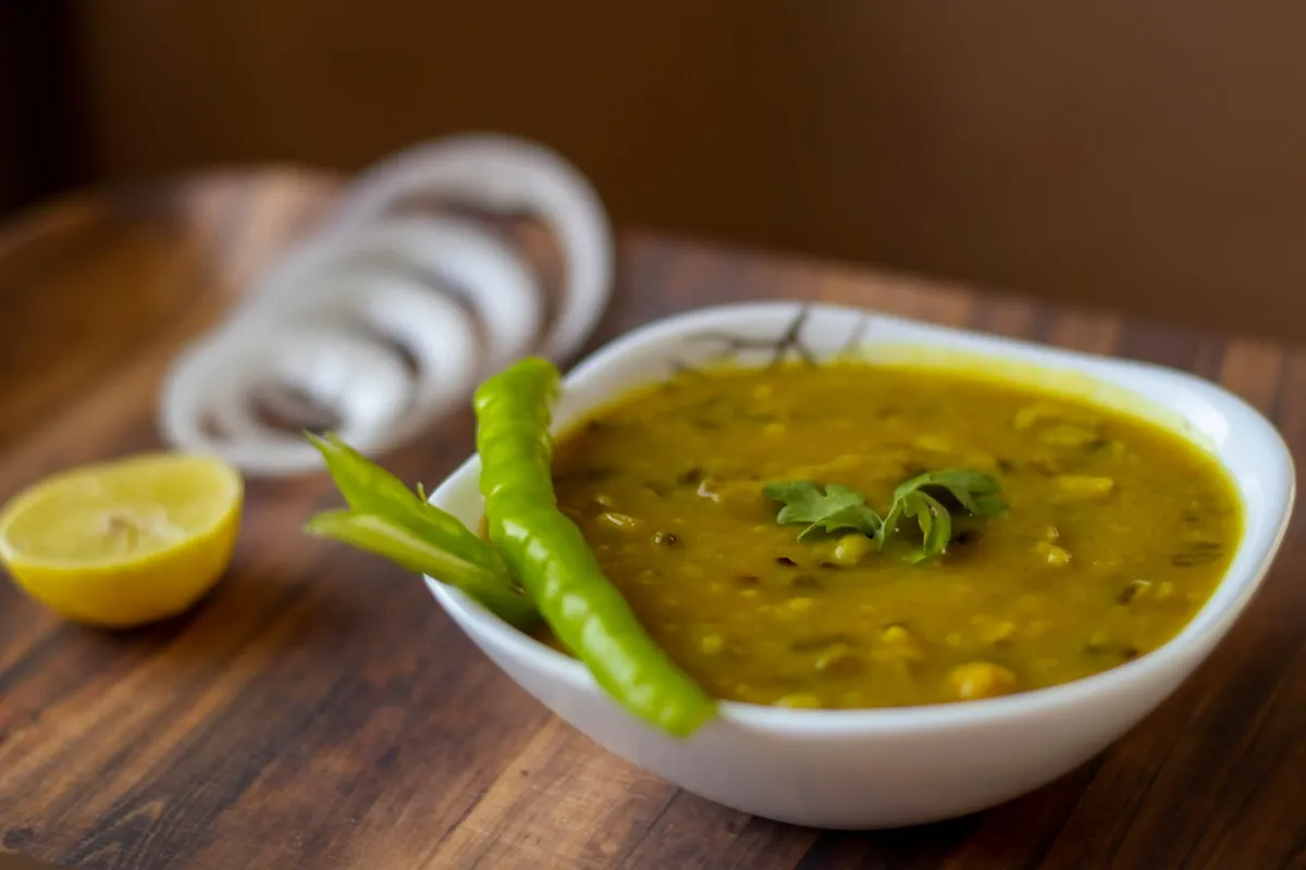 A bowl of yellow dal tadka with a tempering on top