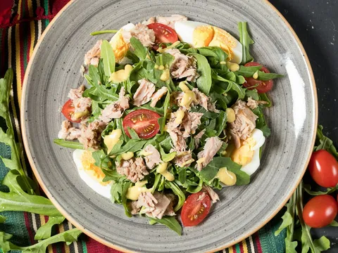 Grilled chicken strips over a salad of greens and vegetables