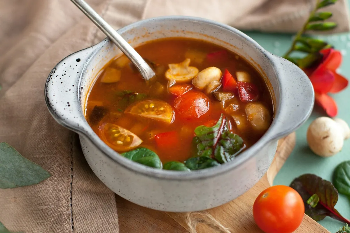 A bowl of clear mixed vegetable soup