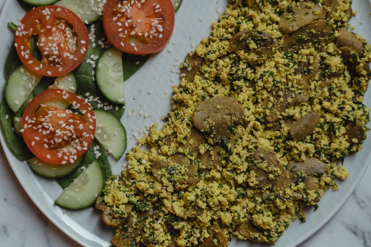 Scrambled tofu bhurji with onion and tomato in a pan